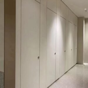 Fully enclosed HPL toilet cubicle for hospitals in a modern, high-traffic restroom setting.